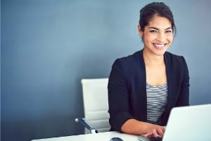 Woman smiling at computer